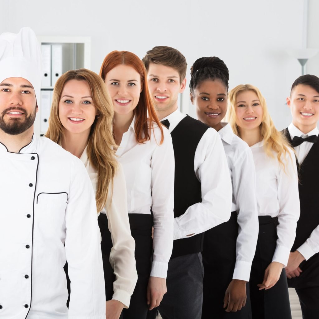 Portrait Of Happy Restaurant Staff Standing In Row